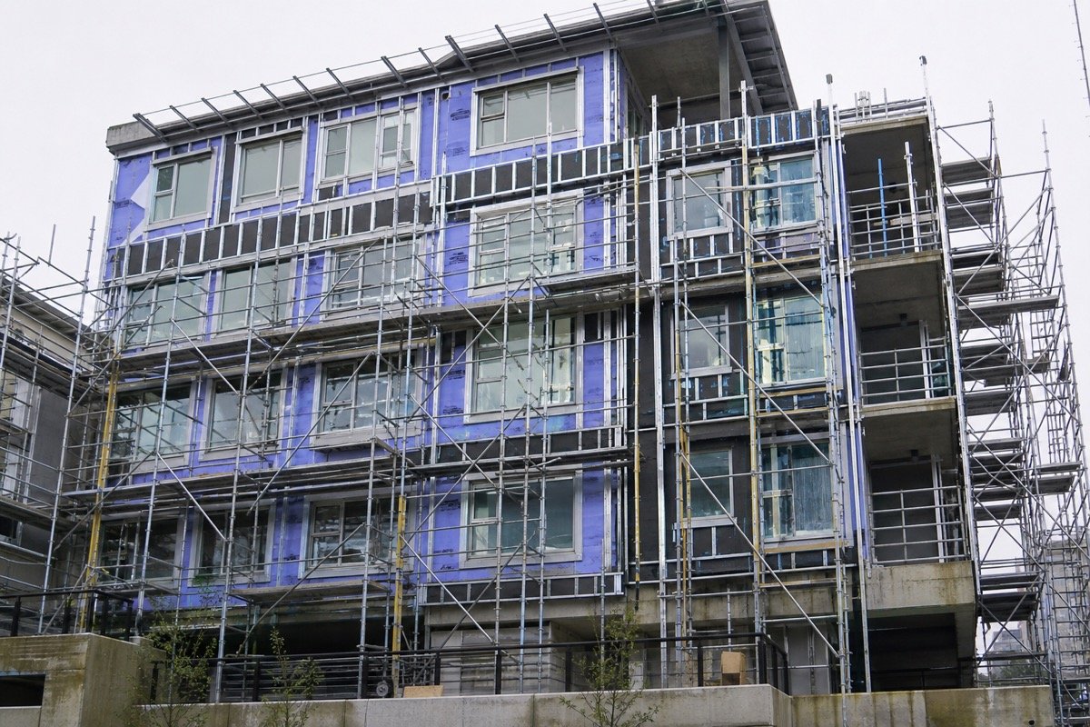Full cladding replacement — 4-storey multi-family — during