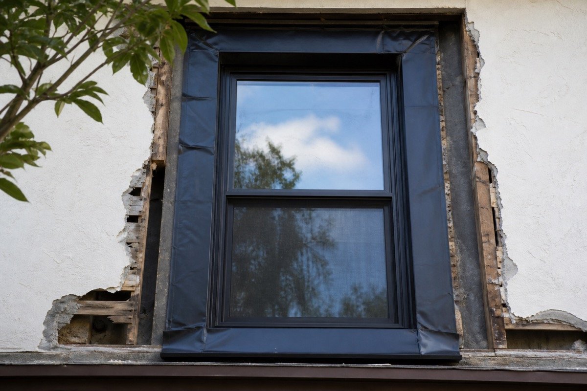 Window and door leak repair — single-family stucco home — during