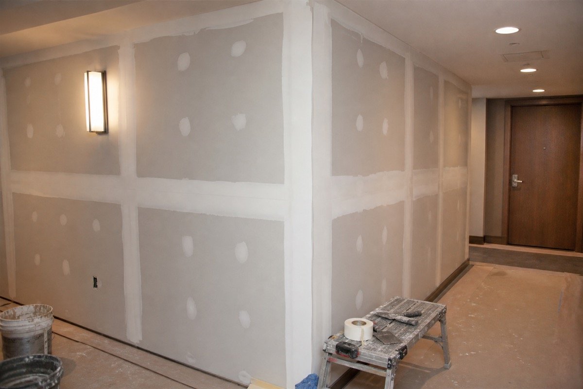 Common area drywall repair after flood — during